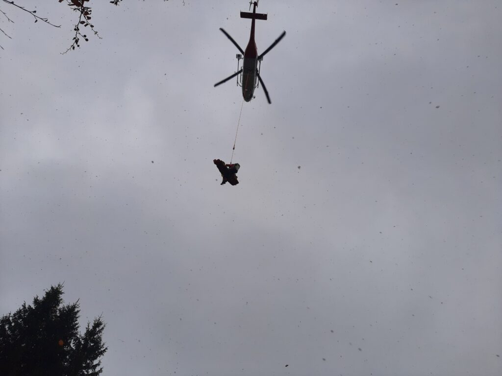 Záchranná akcia HZS - vrtuľníková záchranná zdravotná služba (ATE) v podvese so záchranárom HZS a pacientom na nosidlách vzlieta 