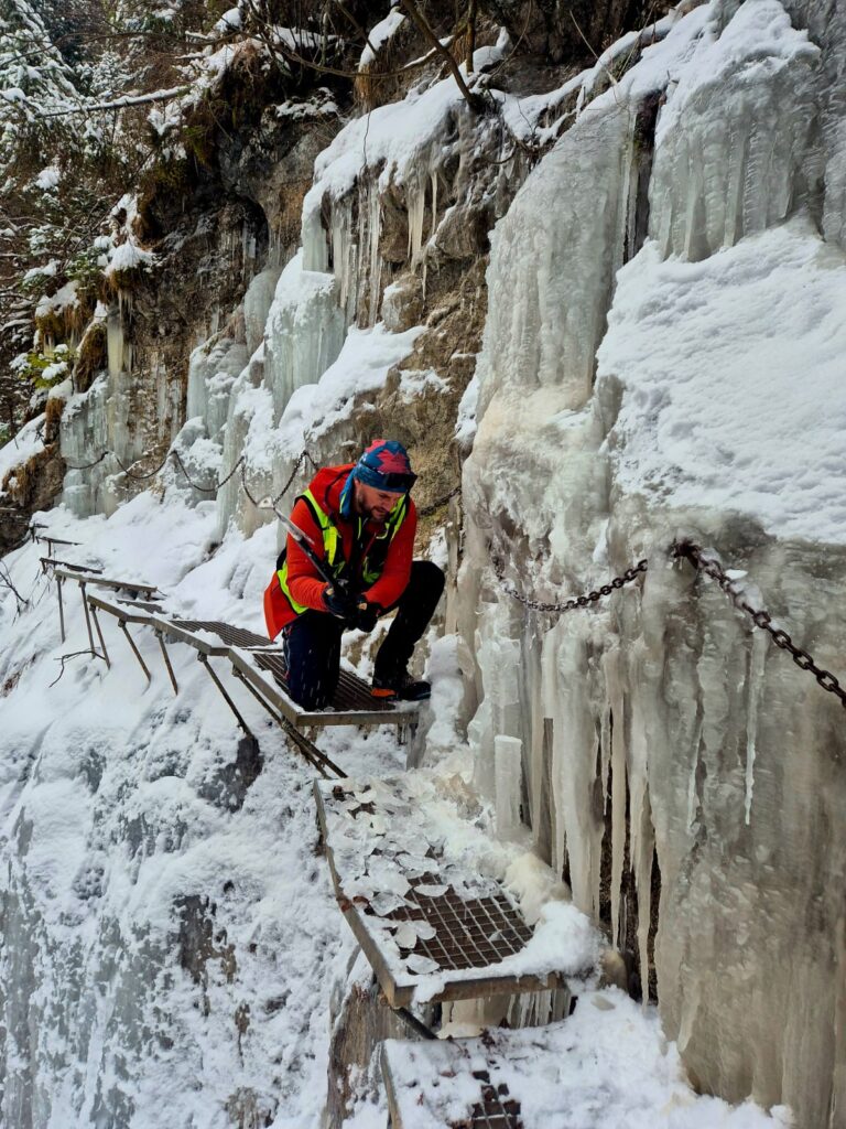 záchranár čistí stupačky a reťaze od ľadu