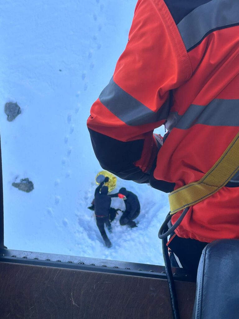 Pohľad z vrtuľníka na troch skialpinistov